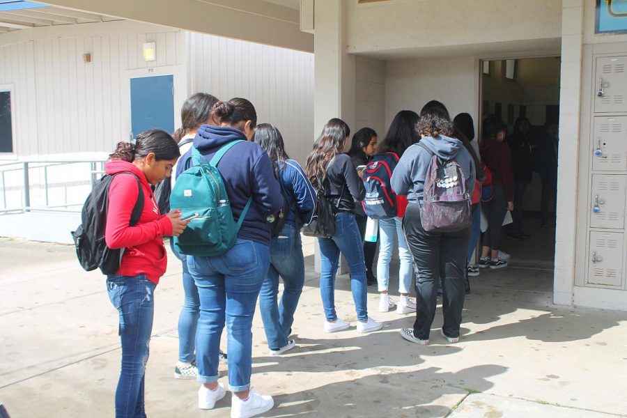 A line forms outside of the girls restroom