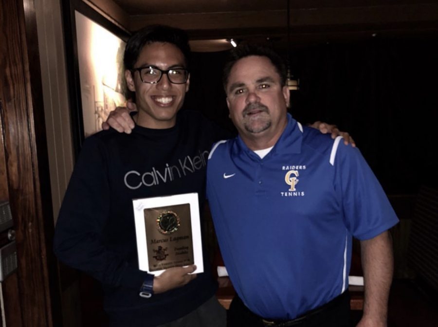 Marcus Lagman gets a tennis award from Coach Brett Zielsdorf