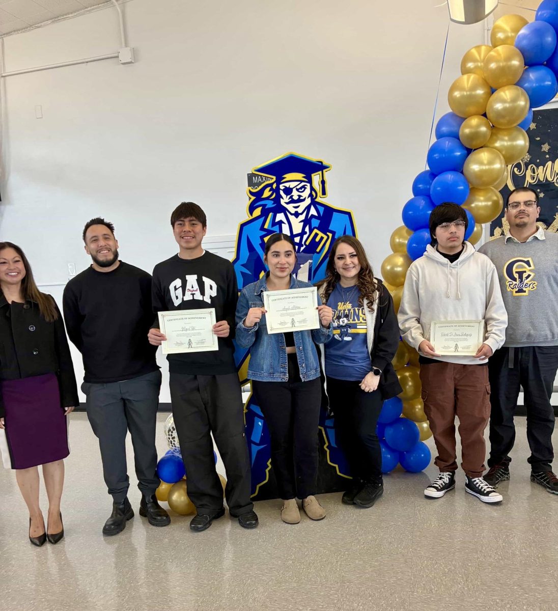 Students pose for a photo with CI staff during the reclassification ceremony on Wednesday